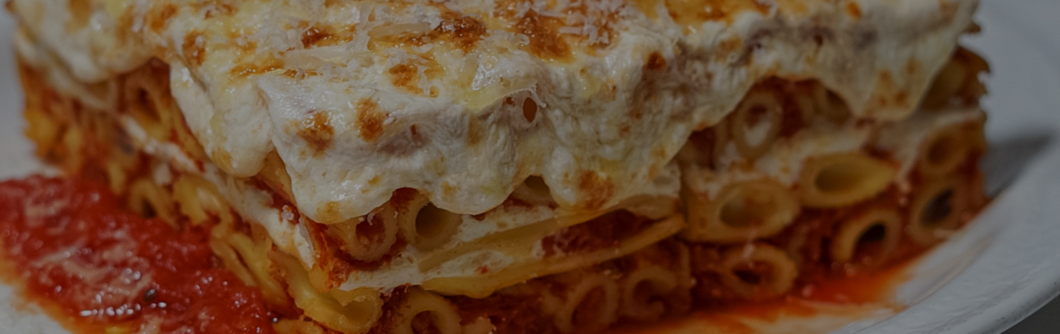 A close up of a delicious baked ziti dish created using Carbone Fine Food's award winning pasta sauces. 