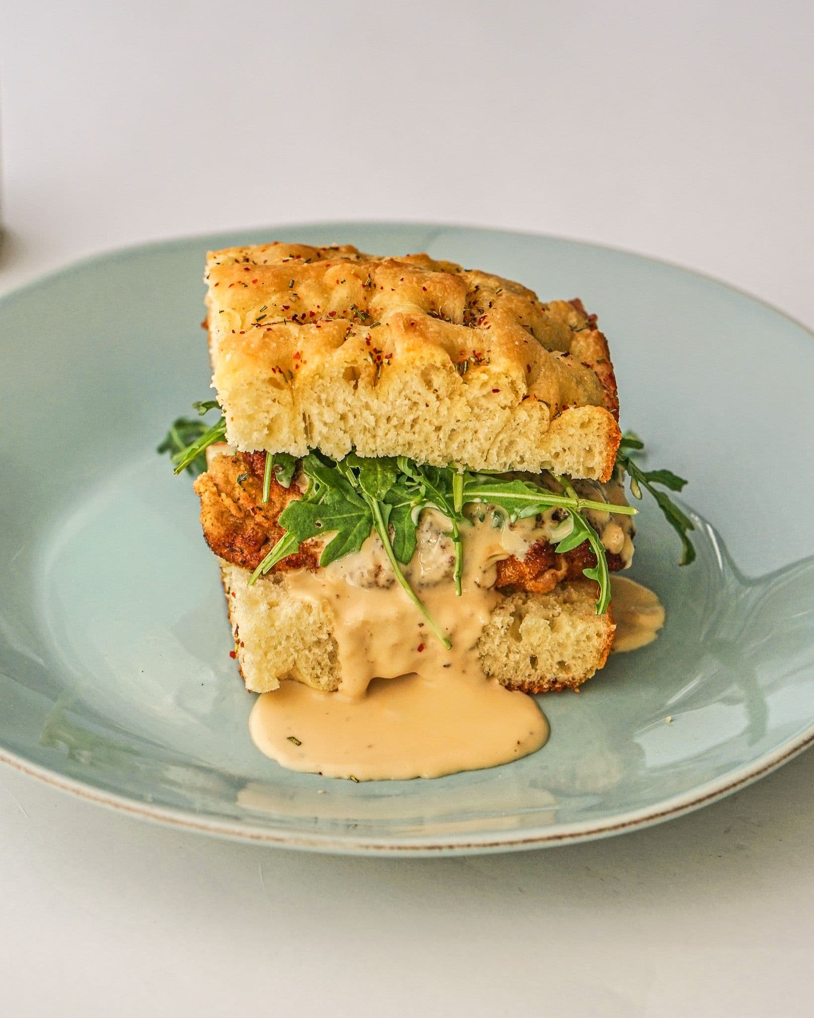 Pork Schiacciata with Truffle Fonduta and Arugula Sandwich